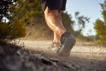 Close up of male muscular legs running up the hill