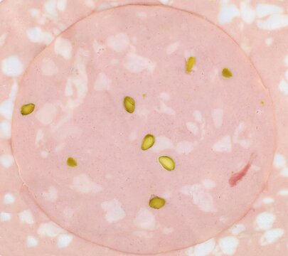 Slice of mortadella with pistachio. It is a large Italian sausage originating from the city of Bologna.Texture.
