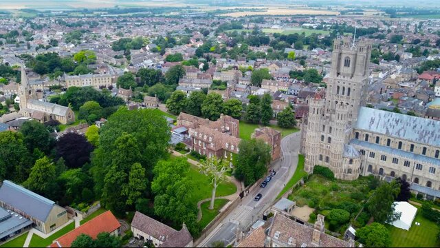 Aerial: urban cityscape with Ely Cathedral tower and street in England