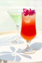 Refreshing summer cocktails in the beach club near the pool. Relaxed atmosphere of vacations, fun, happiness. Luxury lifestyle. Bright colors, hard light and shadows. Close up