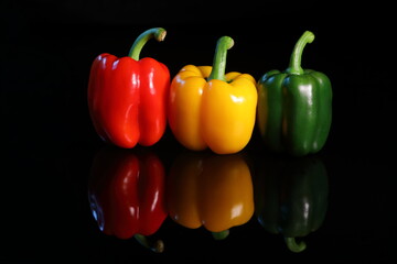 Sweet colorful paprika isolated on dark background with reflex