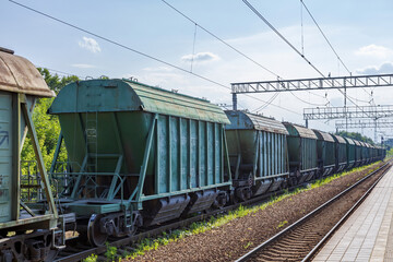 Fototapeta na wymiar Old railway wagons await unloading on the platform of Pavshino station. Moscow Region, Russia