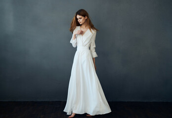 woman white dress fashion elegant style studio dark background posing