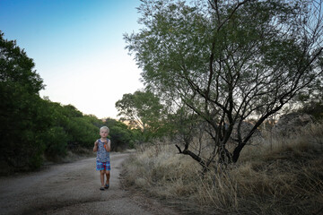 Obraz premium Happy little boy on an afternoon adventure walk in the Australian bush at Mount Hope, Victoria