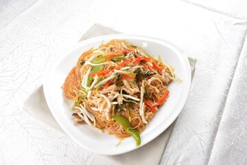 wok fried bee hoon vermicelli thin noodle with seafood and vegetables in chef dark soy sauce in white background asian halal menu