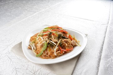 wok fried bee hoon vermicelli thin noodle with seafood and vegetables in chef dark soy sauce in white background asian halal menu