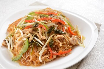 wok fried bee hoon vermicelli thin noodle with seafood and vegetables in chef dark soy sauce in white background asian halal menu