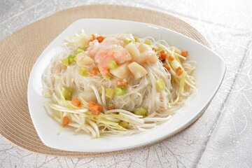 braised wok fried bee hoon vermicelli thin noodle with seafood prawn scallop and vegetables in chef white sauce in white background asian halal menu