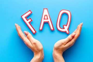 Hands with faq - frequently asked questions - made of paper