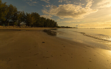 The sea, with the sunshine in the warm morning and the sandy beach.Close-up focus.