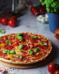 Pizza with salami and basil