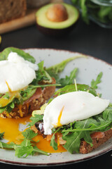 Homemade sandwiches with salmon, avocado and poached eggs