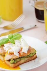 Breakfast with a sandwich with poached egg and avocado