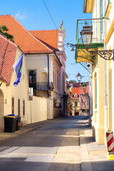 Fototapeta na wymiar Narrow medieval street with historic architecture in the tourist center of Gornji Grad - old Upper town of Zagreb, Croatia