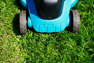 Lawnmower electric machine trimming green grass. Lawn cutting