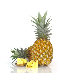 Summer fruit - Ripe pineapple with green  leaves and sliced of fruit isolated on white