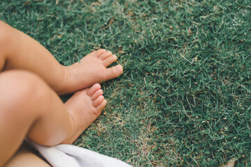 close up a bare foot baby on the grass