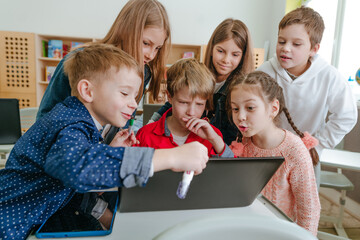 Elementary school students learning in the classroom using laptop