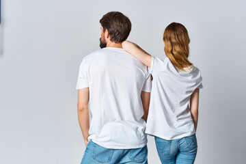 Fototapeta premium man and woman in white t-shirts and jeans design casual clothing mockup