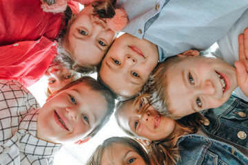 Group of children looking at camera laughing and smiling