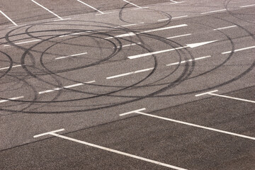 Burned tire marks in the parking lot. Donut tire tracks