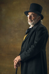 Portrait of elderly gray-haired man, gentleman, aristocrat or actor posing isolated on dark vintage...