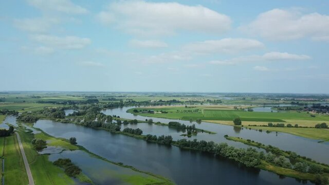 High water level on the floodplains of the river IJssel near the city of Zwolle in Overijssel during summer after heavy rainfall upstream. Aerial drone point of view.