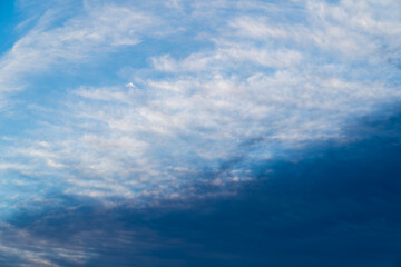 Beautiful blue sky with dark clouds. Daytime sky