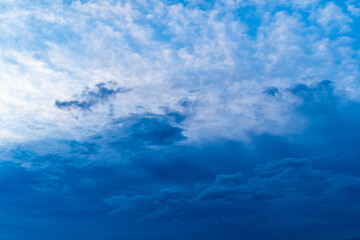 Naklejka na ściany i meble Beautiful blue sky with dark clouds. Daytime sky