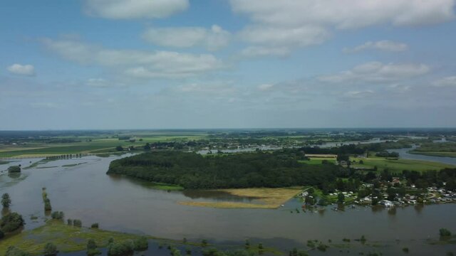 High water level on the floodplains of the river IJssel during summer after heavy rainfall upstream. Aerial drone point of view.