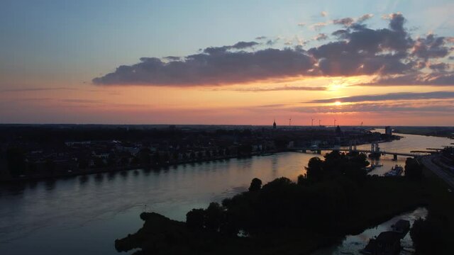 Evening drone view over the river Ijssel and the skyline of Kampen in Overijssel during summer
