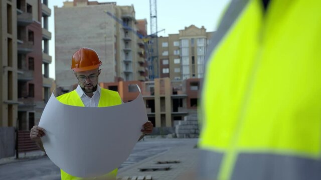 Portrait of young worker with house plan