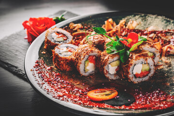sushi roll in plate on black wooden table background