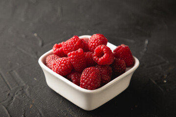 Fresh raspberries on black table