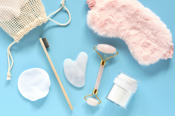 tools for daily care Reusable Discs, Cream Jar, Bamboo Toothbrush, Fluffy Sleep Mask, Roller Quartz Facial Massager and Guasha Scraper for Facial Massage Flatlay with modern tools for facial skin care