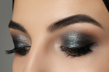 Young woman with evening makeup, closeup. Eye shadow product - obrazy, fototapety, plakaty