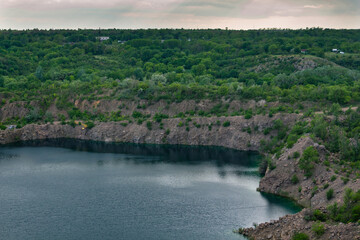 rocky cliff and lake, quarry lakes and beautiful sky after a thunderstorm