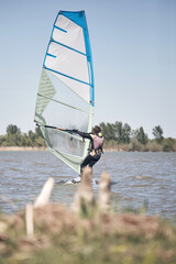 Windsurfer surfing on a windy summertime day at the river.