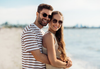 summer holidays and people concept - happy couple on beach