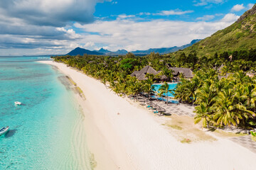 Luxury tropical beach with blue ocean in Mauritius. Sandy beach with palms. Aerial view