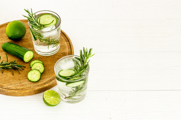 Lemonade with cucumber lime and herbs in glasses