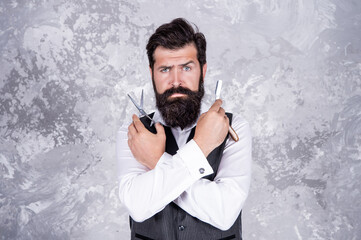 mature bearded man hipster in hairdresser salon with tools of vintage razor and scissors, hairstyle.