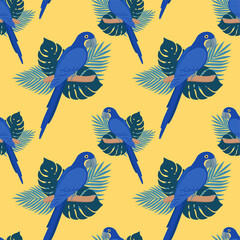 Seamless pattern with parrots and leaves. Hyacinth macaw on yellow background. Vector design for paper, cover, fabric, gift wrap, interior.