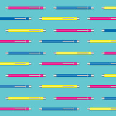 Geometric pattern of colored pens on blue background