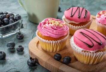 Strawberry yogurt cupcakes for tea. Sweets with tea. Strawberry sweet cupcakes.