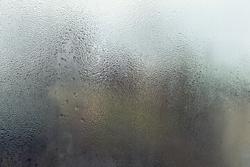 Fototapeta na wymiar texture of a window closeup, glass with water droplets