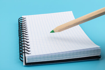 Blank paper and pencil on a blue background