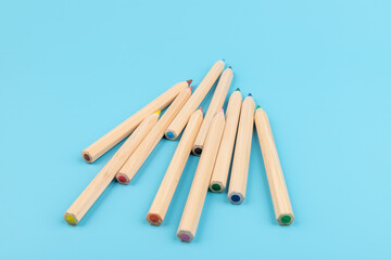 Wooden colorful ordinary pencils isolated on blue background. Back to school