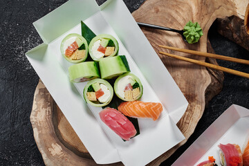 Sushi roll without rice in white paper box. Delivery service concept. Japanese food in eco-container. Top view. Waste-free packaging. High quality photo