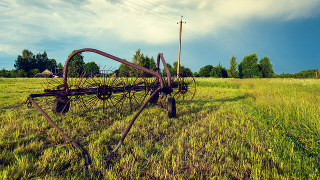 Old-time harvest machine. Old farm equipment. Hay-making